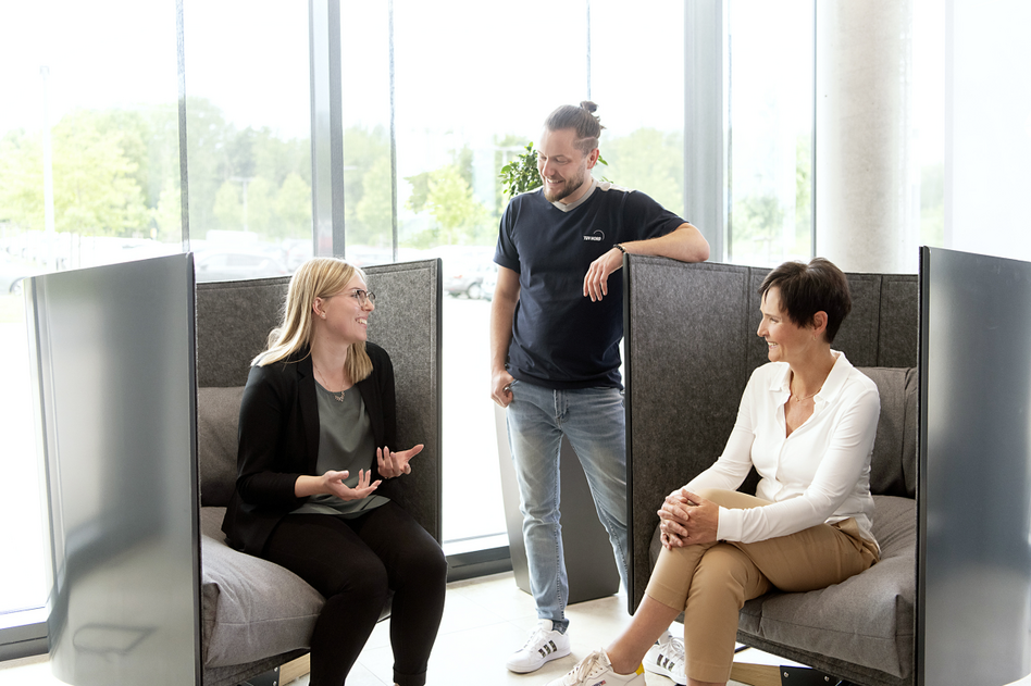 Three colleagues sitting together and talking