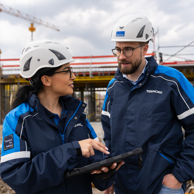 Two engineers talking in front of a building